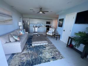 a living room with a couch and a kitchen at Buck island Breeze in Christiansted