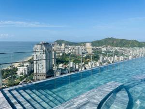 a swimming pool with a view of the city at The Sóng Vũng Tàu - Căn Hộ Nghỉ Dưỡng, Hồ Bơi Vô Cực & Gần Biển - Mr T in Vung Tau