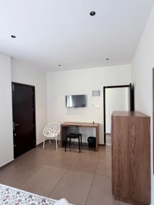 a living room with a table and a chair at Cozy Nook Inn - A BB Linens Experience in Vythiri