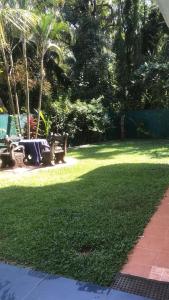 a park with a bench in the grass at Feel side villa in Induruwa