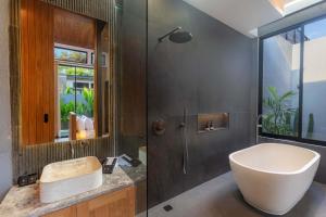 a bathroom with a sink and a toilet and a shower at Anasera Villas Echo Beach Canggu in Canggu