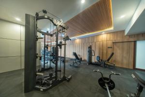 a gym with several tread machines in a room at Horison IJ Kudus in Kudus