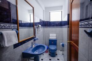 a bathroom with a blue sink and a toilet at Quechua Hostal Recoleta in Cusco +70 photos