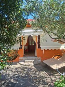 an orange and white house with the door open at Casa Vacanza Gaia Relax Pula in Pula