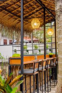 an outdoor bar with chairs and lights at Wake N Flow, Hiriketiya Beach in Hiriketiya