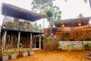 a house with a thatched roof and plants in front at Wake N Flow, Hiriketiya Beach in Hiriketiya +30 photos