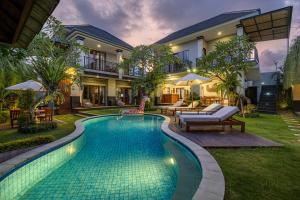 a swimming pool in the backyard of a house at Cove Ayuna in Canggu