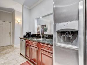 a kitchen with a refrigerator with glasses in it at Historic Savannah Condo, Sleeps 6, Pool, Dogs Ok in Savannah