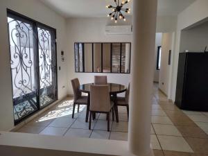 a dining room with a table and chairs at Casa Mojave in La Paz