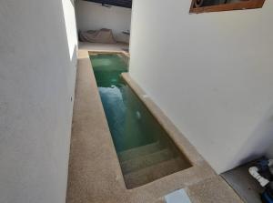 a small swimming pool in the middle of a building at Casa Mojave in La Paz