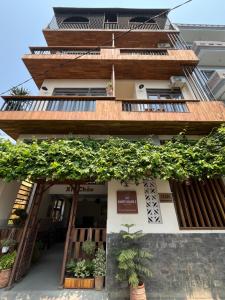 a building with plants on the side of it at Hue Sweethouse 2 Homestay in Hue