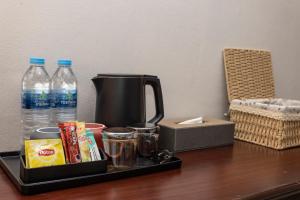 a tray with a coffee maker and drinks on a table at The Chic Patong Hotel in Patong Beach