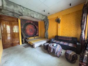 a bedroom with a bed and two chairs in it at Homestay River Green in Làng Lap +4 photos