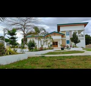 a large white house with a large yard at The Avenue Hotel and Event Center in Manaoag