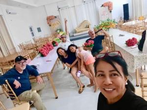 a group of people sitting around a table at The Avenue Hotel and Event Center in Manaoag