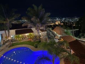 a house with a swimming pool at night at hotel la ermita suites in San Miguel de Allende