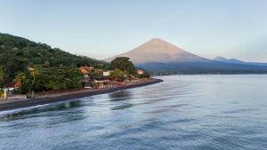 a view of a river with a mountain in the background at Salty Breeze Amed in Ambat