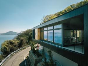a house with a view of the water at Villa CASK Setouchi in Mitoyo
