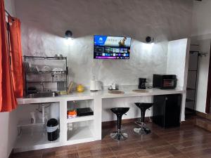 a kitchen with a counter and stools in a room at Don Lioni in El Valle de Antón +16 photos