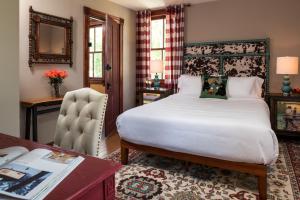 a hotel room with a bed and a desk and a desk at Pine Brook Manor in Sparrow Bush