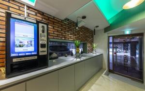 a bar with a large television in a store at My 24 Motel in Incheon