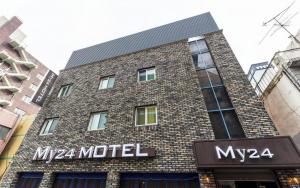 a large brick building with a sign on it at My 24 Motel in Incheon