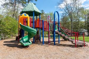 a playground with a slide and a play structure at 2 Homes • Pool + Amenities • Sleeps 16 in Swain
