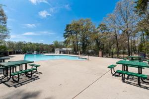 a picnic area with picnic tables and a pool at 2 Homes • Pool + Amenities • Sleeps 16 in Swain