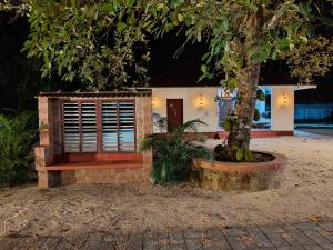 a house with a tree in front of it at Eden Casa in Mararikulam