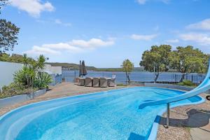 a swimming pool with a view of the water at Waterside Escape St Hubert s Island in Saint Huberts Island
