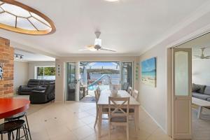 a dining room and living room with a table and chairs at Waterside Escape St Hubert s Island in Saint Huberts Island