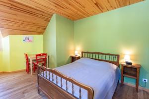 a bedroom with a bed and a table and chairs at L'oustal de lucie in Saint-Saturnin-de-Tartaronne