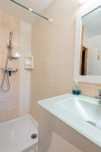 a bathroom with a tub and a sink and a mirror at L'oustal de lucie in Saint-Saturnin-de-Tartaronne +24 photos