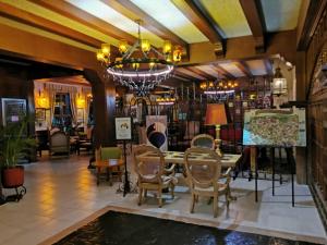 a dining room with a table and chairs and a chandelier at hotel la ermita suites in San Miguel de Allende