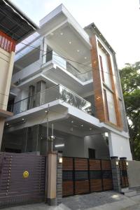 a large house with a gate in front of it at Aadhya Abode Holiday Home in Kanyakumari