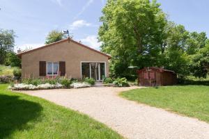 a house with a gravel driveway in front of it at La source du cellier 4/6 personnes in Saint-Jean-la-Fouillouse