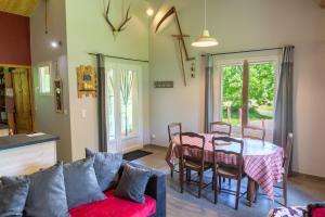 a living room with a couch and a table at La source du cellier 4/6 personnes in Saint-Jean-la-Fouillouse