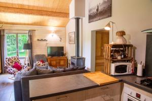 a kitchen with a couch and a living room at La source du cellier 4/6 personnes in Saint-Jean-la-Fouillouse +20 photos
