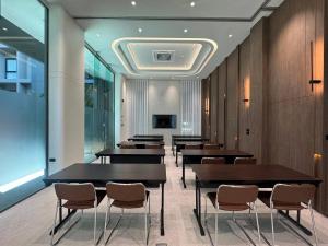 a row of tables and chairs in a room at โรงแรมแชปเตอร์ หาดใหญ่ - Chapter Hotel Hatyai in Sathani Khlong Rian