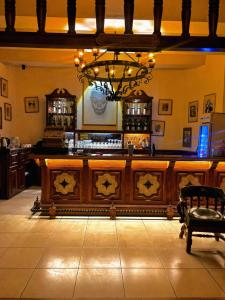 a bar with a chandelier and a bench in a room at hotel la ermita suites in San Miguel de Allende