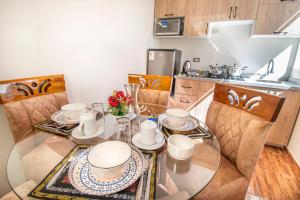 a dining room with a glass table and chairs at Samakuy Home Arequipa in Arequipa