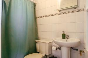 a bathroom with a toilet and a sink at Gatalegre Hostel in Valparaíso +38 photos