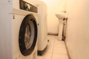 a washing machine in a bathroom with a toilet at Gatalegre Hostel in Valparaíso