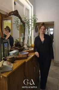a woman standing in front of a vanity in front of a mirror at GAP Cairo Hotel Downtown in Cairo