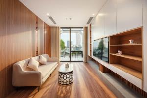 a living room with a couch and a table at BRIO Ventura Apartment in Danang