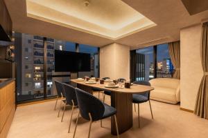 a dining room with a table and chairs and a large window at Hotel EN-YO in Tokyo