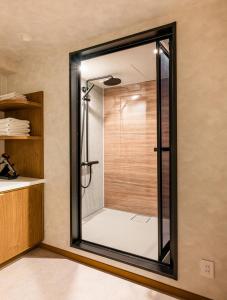 a shower in a bathroom with a mirror at Hotel EN-YO in Tokyo +11 photos