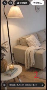 a living room with a lamp and a couch at Cozy Suite Kirchheim, Parkplatz, Nähe A8, Souterrain in Kirchheim unter Teck