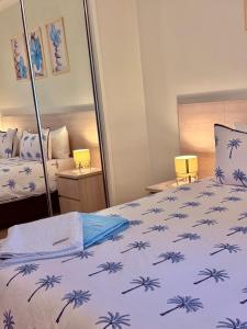 a bedroom with a bed with a blue and white blanket at Reefside Escape Silkari Resort in Port Douglas +48 photos