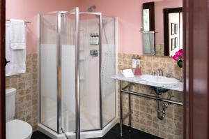 a bathroom with a shower and a sink at Pine Brook Manor in Sparrow Bush +48 photos